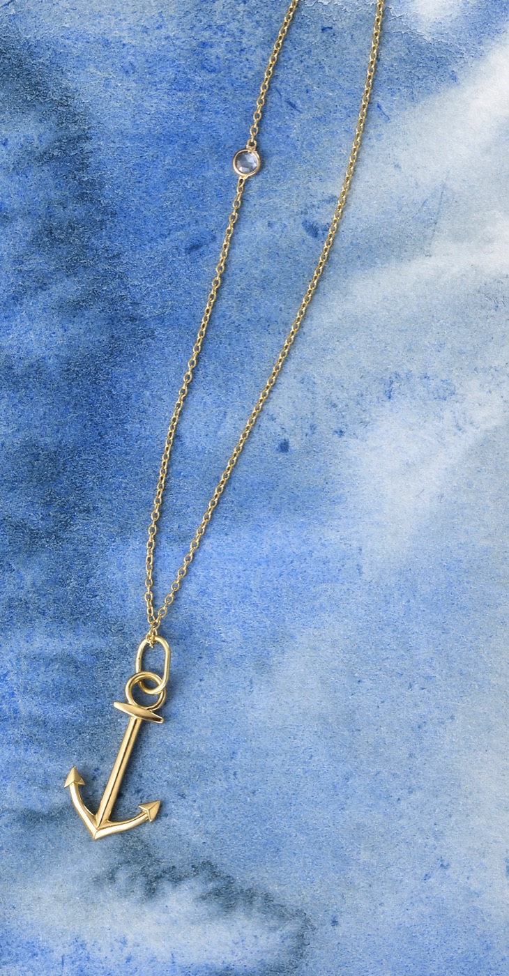 a delicate 18k gold anchor pendant with a rose cut diamond on a fine chain