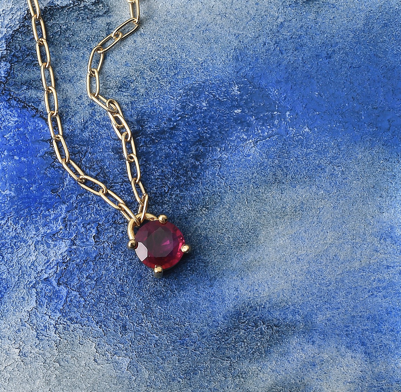 a brilliant cut ruby on a delicate 18k gold chain